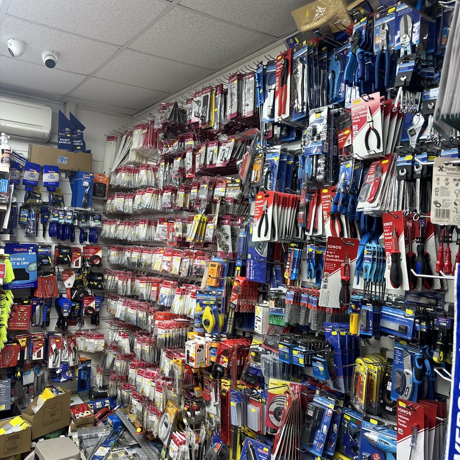 A full wall of hand tools and hardware