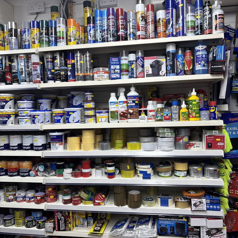 Tins of paint and primer on the shelves